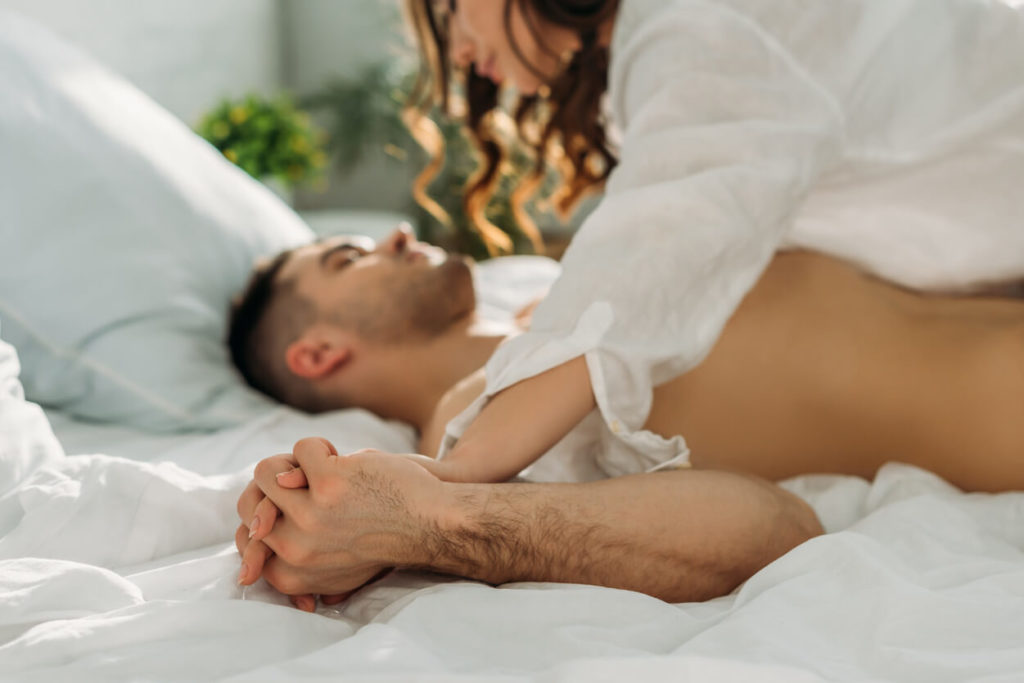 boston couple fucking on bed passionately while holding hands