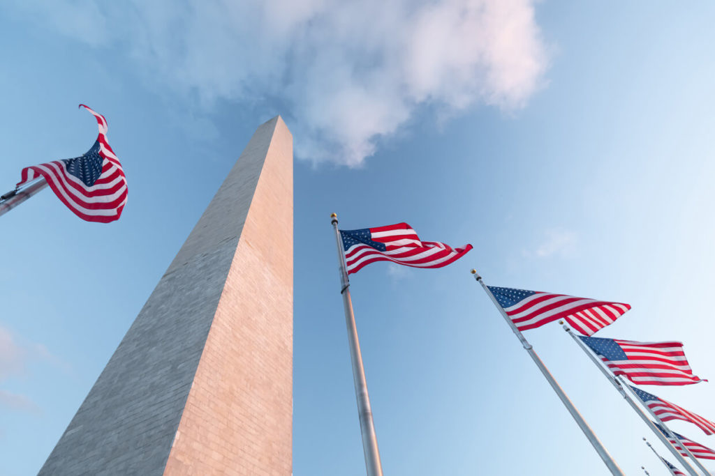 a monument and flag of united states in washington dc