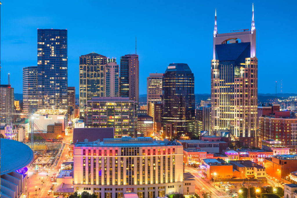 a view of nashville tennessee at night with buldings in light
