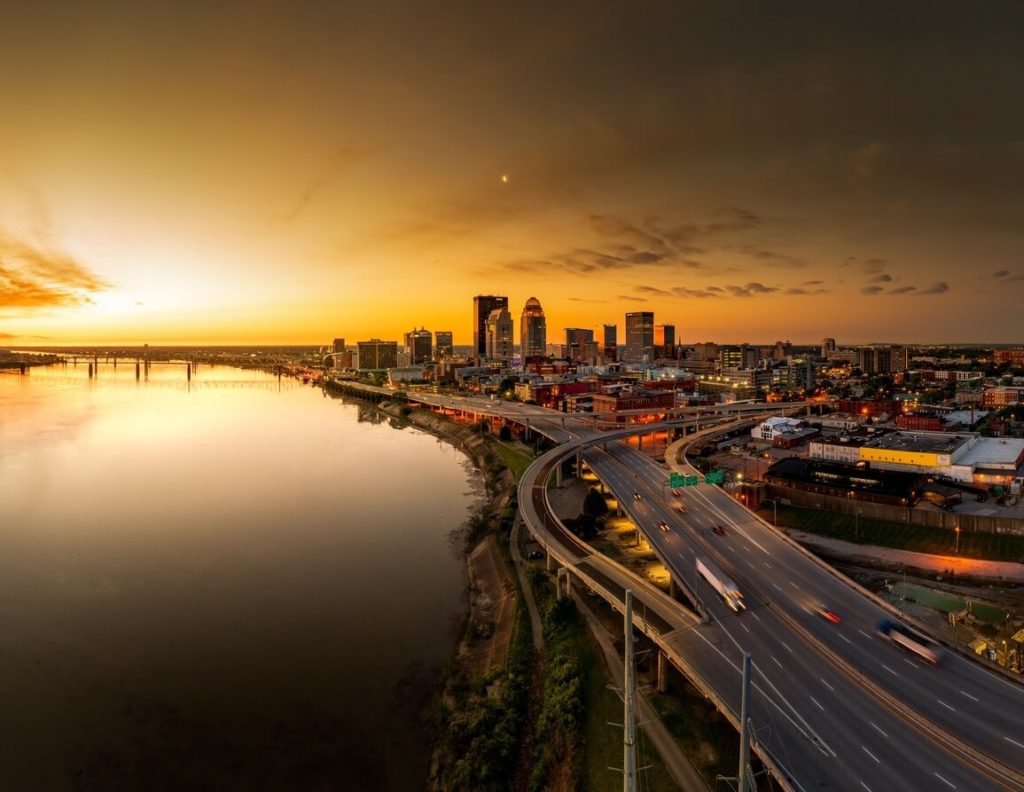 a nice view of louisville before at night showing in the pictures is the city view with buildings and highways