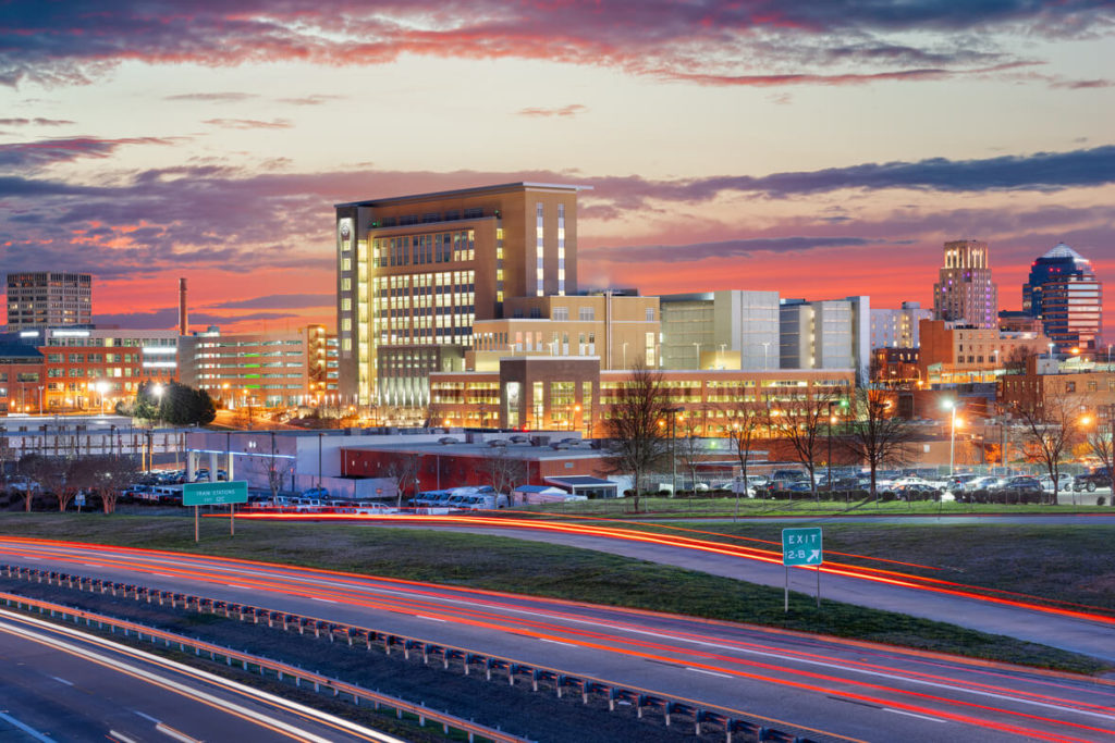 durham city north carolina during at night with buildings full of lights